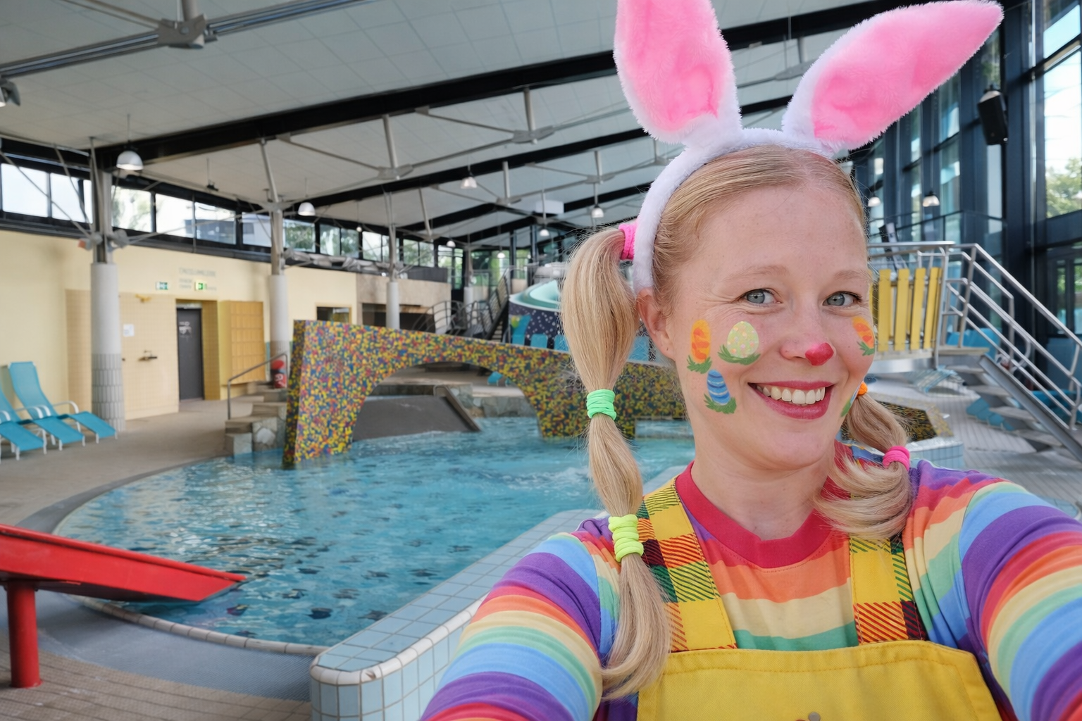 Frau im Osterhasenkostüm im Schwimmbad