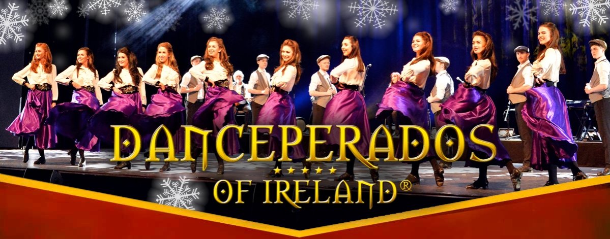 Das Bild zeigt eine Gruppe von Tänzern der "Danceperados of Ireland" in einem Weihnachtsauftritt. Die Künstler präsentieren irischen Stepptanz in festlicher Atmosphäre, mit einem beleuchteten Bühnenbild und Schneeflocken als Teil des Designs.