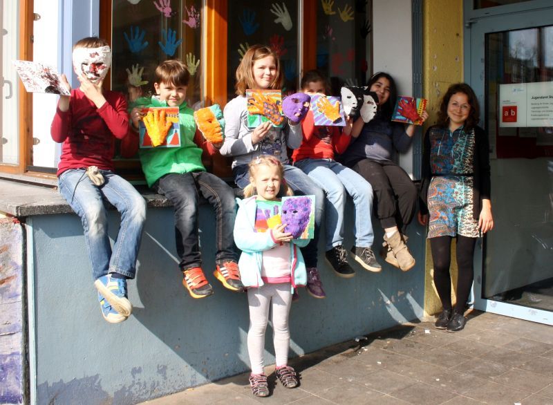 Farbenfrohe Masken: Darya Shatalova (rechts) mit den kleinen Künstlern am Stadtteilhaus FWH.