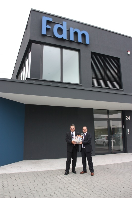 Wirtschaftsförderer Thomas Zacharias hieß Geschäftsführer Guido Faust herzlich willkommen und überreichte ihm das „Troisdorfer Willkommenspaket“, einen Geschenkkorb mit Lebensmittelspezialitäten aus Troisdorf.