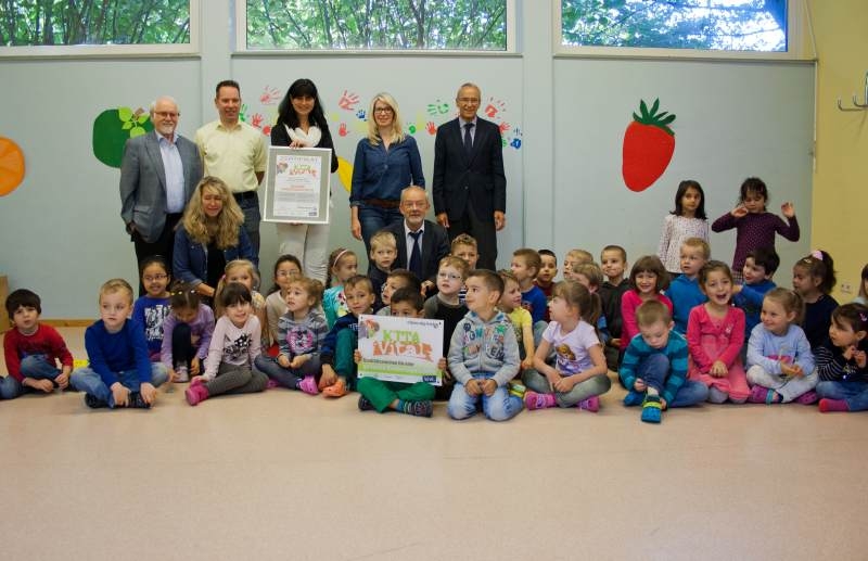 Große Freude bei Jung und Alt: Kita-Leiterin Sigrid Hafki erhielt das Zertifikat von Sozialdezernent Hermann Allroggen im Beisein von Vize-Bürgermeister Rudolf Eich, Stiftungsvorsitzender der VIK Stiftung Klaus Michel, Projektbetreuerin Yasmin Gros.
