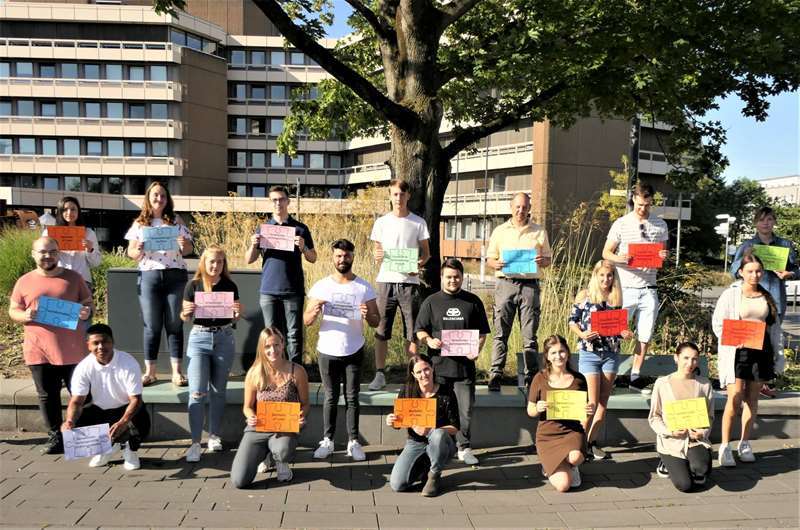 Mit Abstand und Arbeitseifer: Die neuen Auszubildenden der Stadtverwaltung weisen mit Puzzleteilen auf ihre zukünftigen Berufe hin.