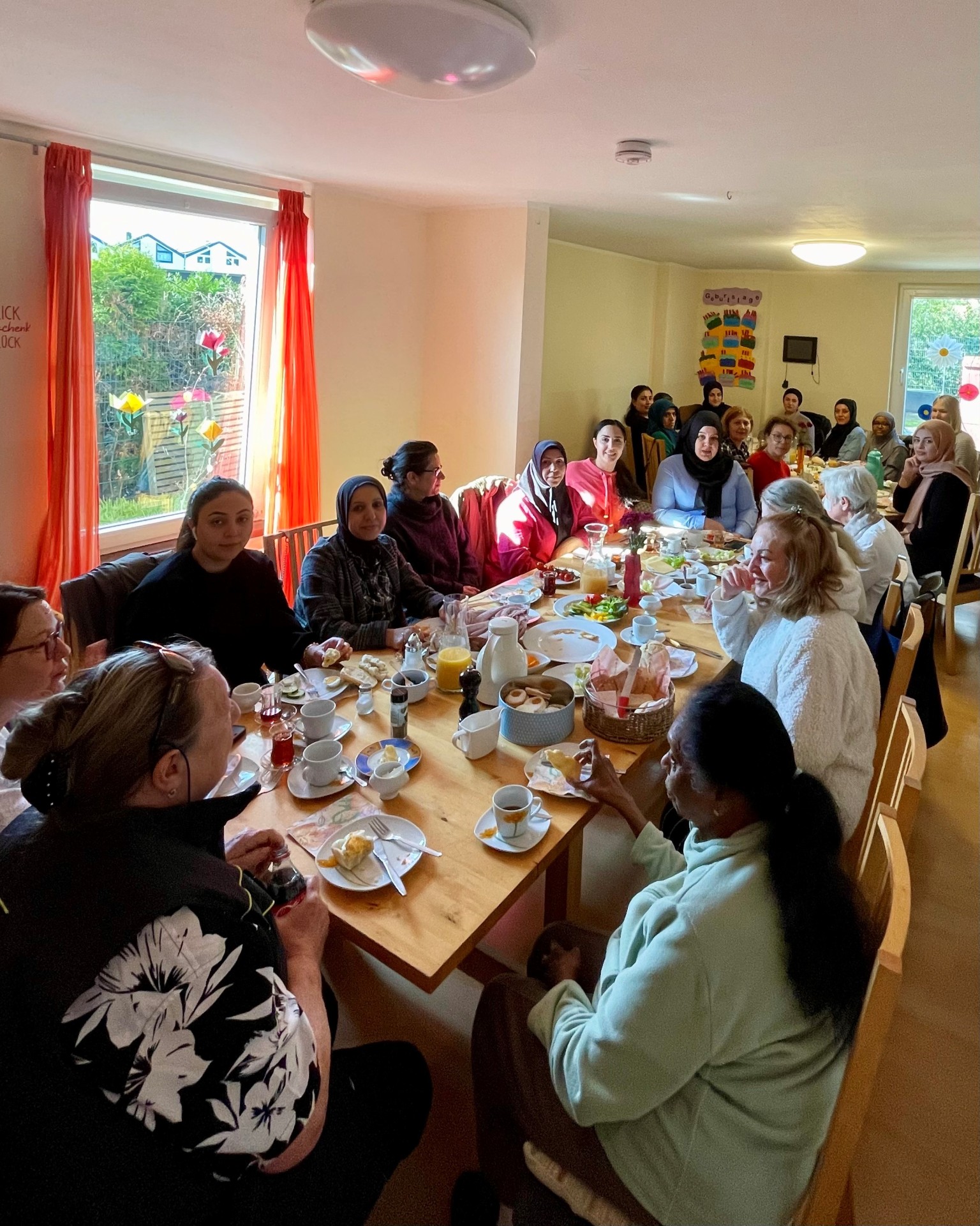 Frauen aus verschiedenen Ländern sitzen am Frühstückstisch
