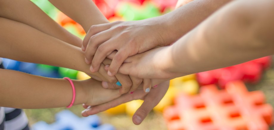 Kinderhände greifen zusammen