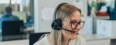 Büromitarbeiterin mit Headset Person telefoniert